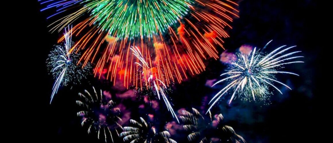 Colored fireworks display on dark sky background