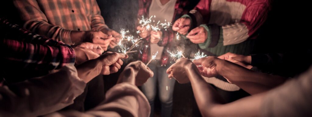 Fireworks burning sparkler in human hands in new year party