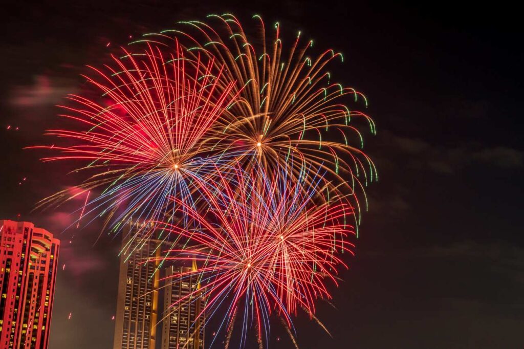 vibrant red fireworks on the river