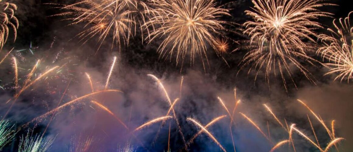 vibrant firework display above a bridge