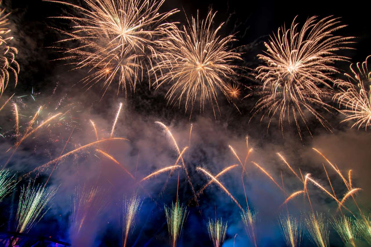 vibrant firework display above a bridge
