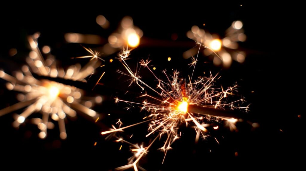 Two burning sparklers illuminating the dark