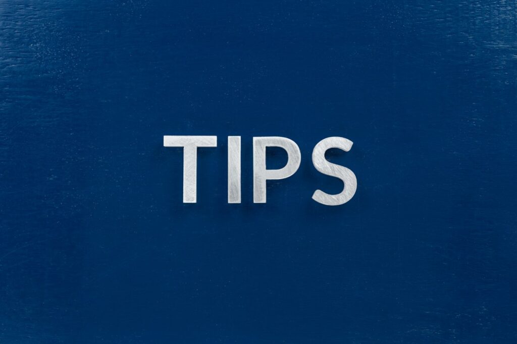 the word tips laid with silver letters on blue color surface