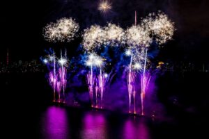 Colored fireworks display on dark sky background