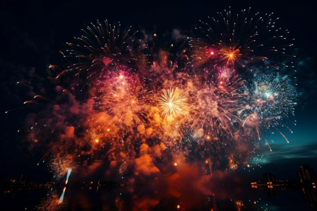 fireworks over the water in the night sky