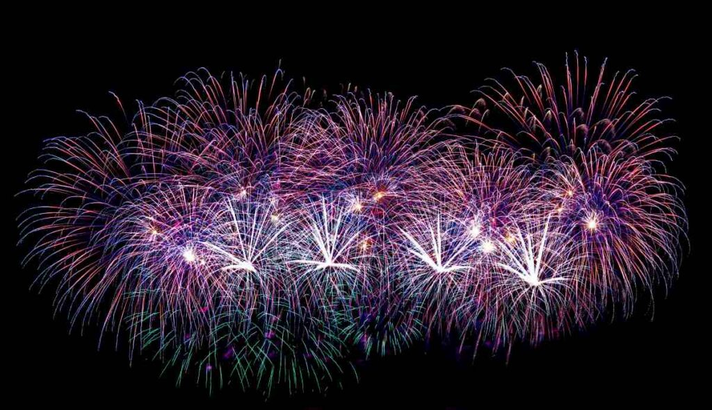 Colorful celebration fireworks isolated on a black sky background