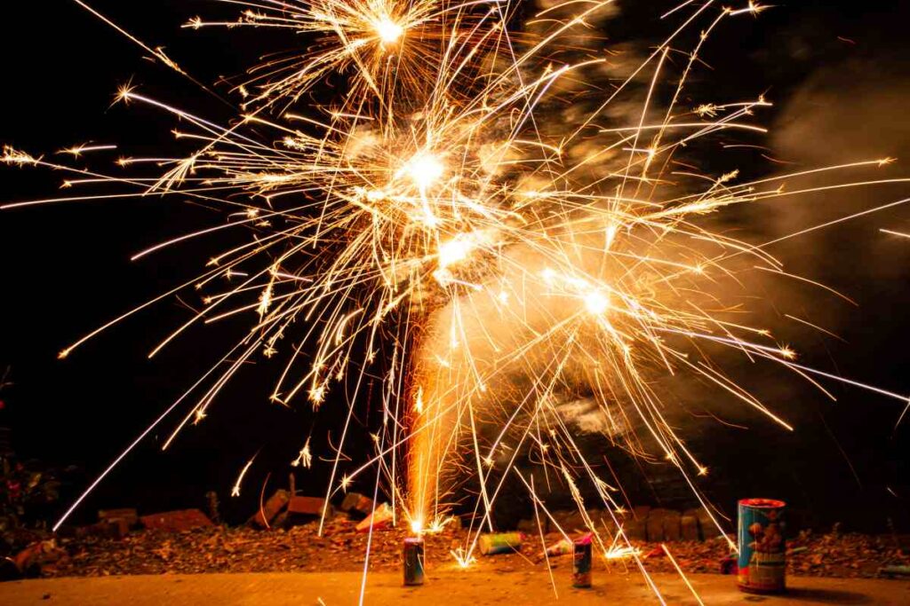 Vibrant fireworks exploding in the night sky, showering sparks and light