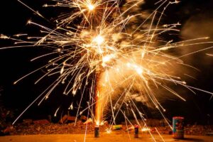 Vibrant fireworks exploding in the night sky, showering sparks and light