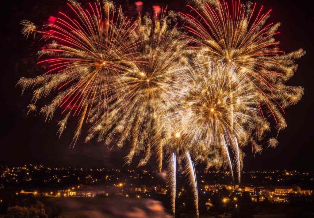 Golden and red fireworks spreading across the sky