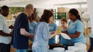 non-profit food drive event multicultural group of volunteers