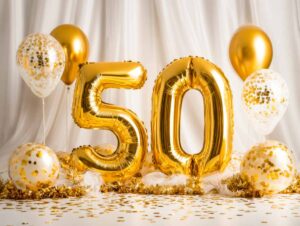 Elegant celebration decor for a 50th milestone with gold balloons and festive accents